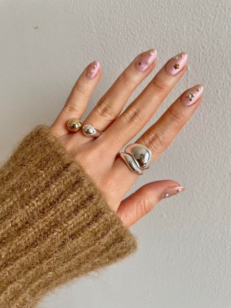 sheer sparkly pink nails with gems and rhinestones on top