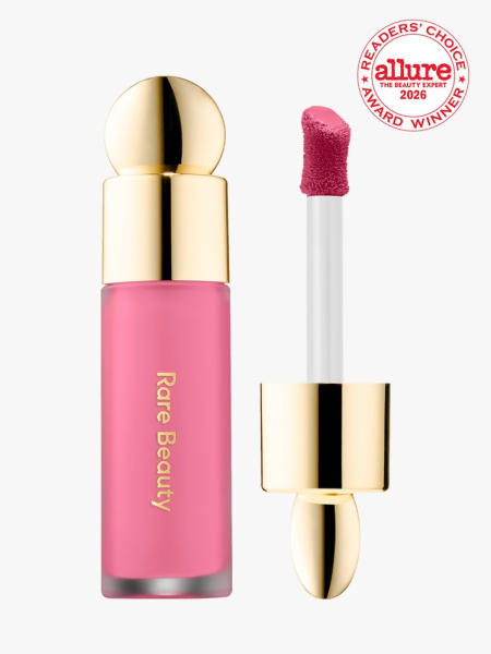 Clear tube of Rare Beauty Soft Pinch Liquid Blush with blush brush on white background