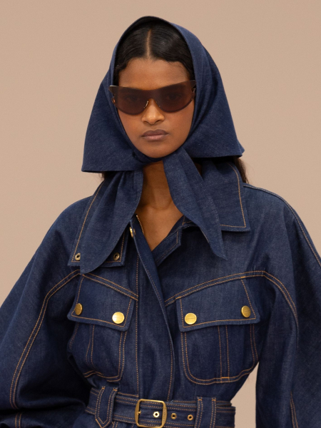 A model walks the runway during the Zimmermann Womenswear SpringSummer 2026 show in a mini denim dress and matching...