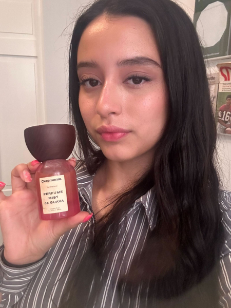A selfie of Allure designer Briana Rengifo holding a bottle of Ceremonia Perfume Mist de Guava